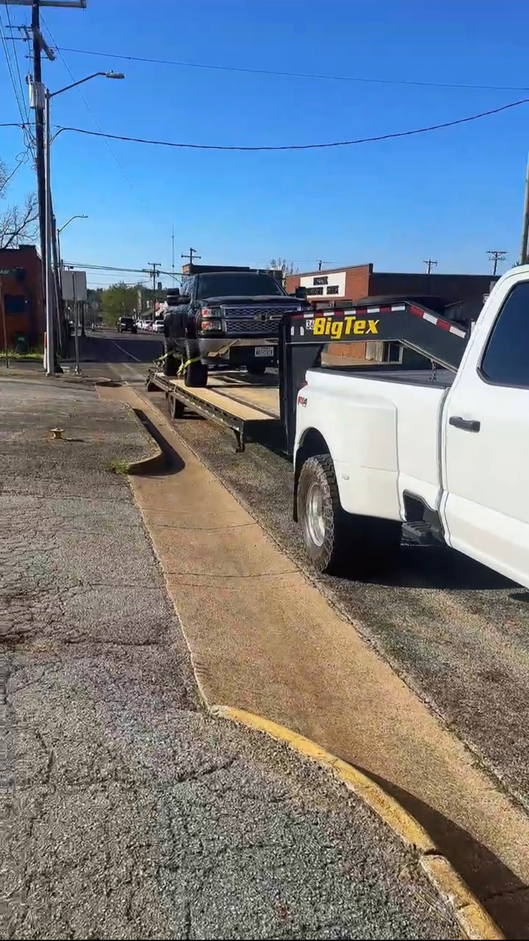 Ford dually hauling a lifted Chevy Silverado on a BigTex gooseneck trailer