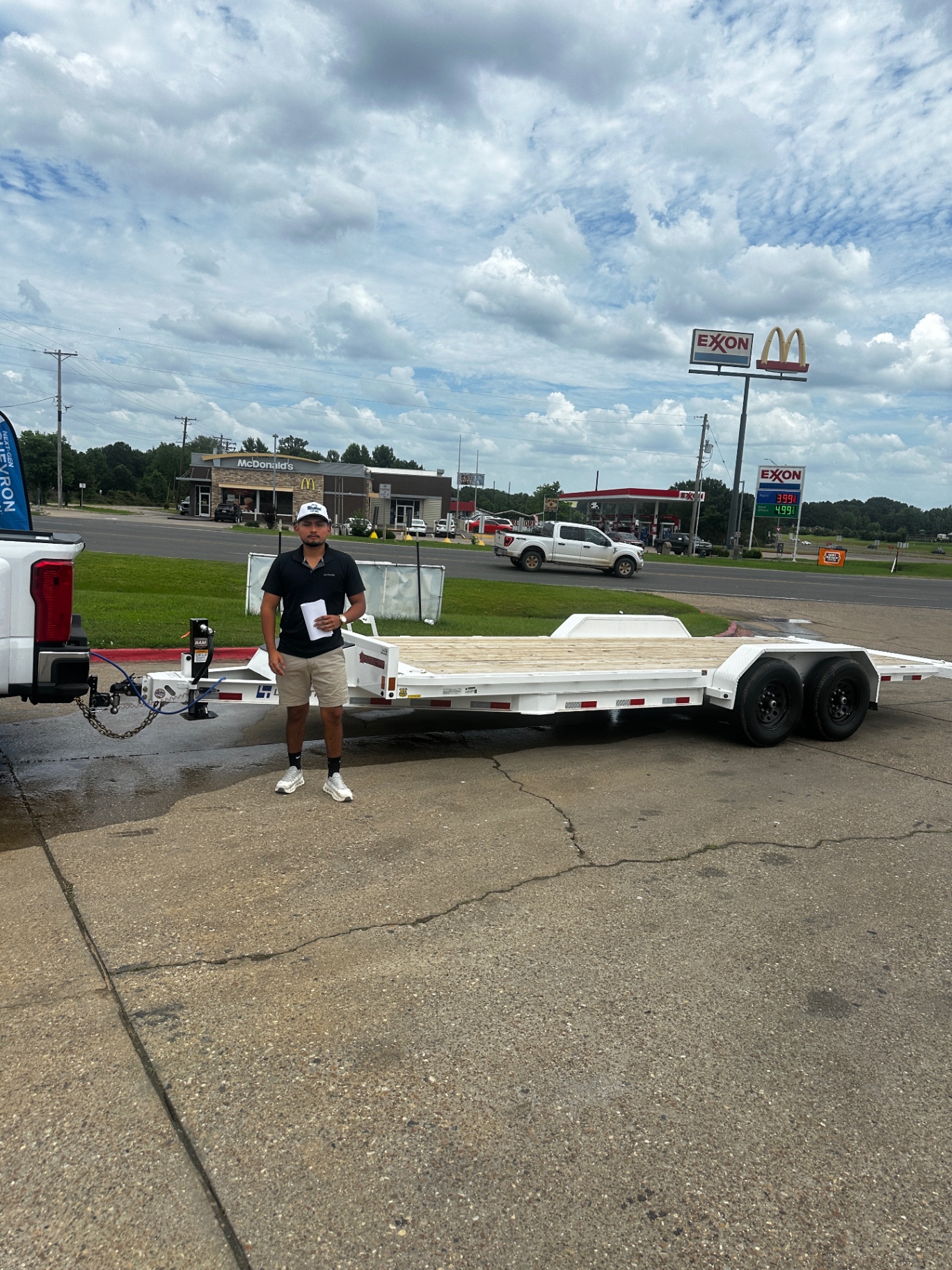 Driver standing by a fresh white car-hauler trailer in Henderson, TX